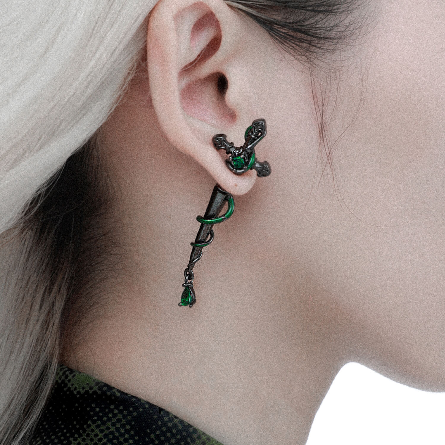 Each stud features two green zircons, heightening the allure of this unique piece. The option of silver or black ensures a striking aesthetic that challenges traditional norms, making these earrings a standout addition to your collection.